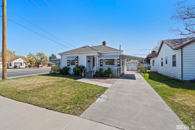 746 6th St, Sparks, NV 89431 - view of front of home featuring a front yard, a chimney, concrete driveway, an outdoor structure, and an attached carport