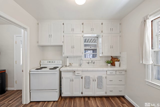 746 6th St, Sparks, NV 89431 - kitchen featuring white range with electric cooktop, white cabinets, dark wood finished floors, and healthy amount of natural light