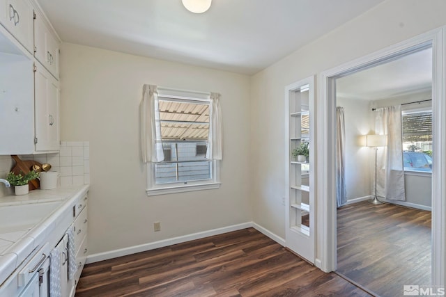 746 6th St, Sparks, NV 89431 - kitchen with dark wood-type flooring, white cabinets, a sink, and baseboards