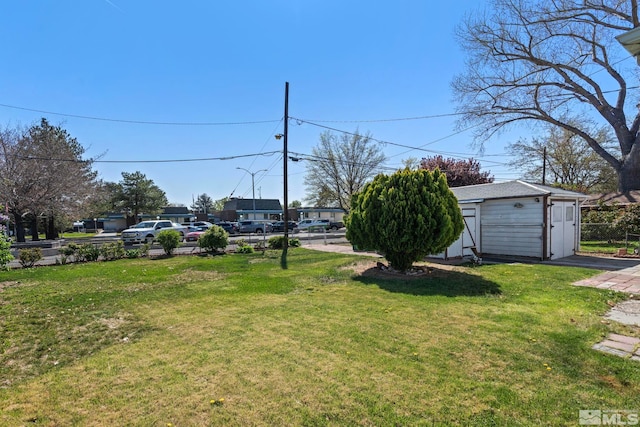 746 6th St, Sparks, NV 89431 - view of grassy yard featuring a detached garage and an outbuilding