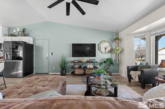 2036 Flycatcher Ct, Sparks, NV 89441 - living area featuring lofted ceiling, ceiling fan, light wood finished floors, and baseboards