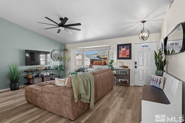 2036 Flycatcher Ct, Sparks, NV 89441 - living area with wood finished floors, lofted ceiling, a ceiling fan, and a chandelier