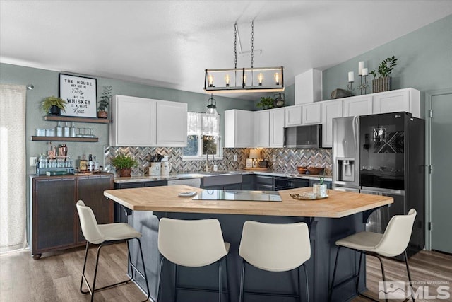 2036 Flycatcher Ct, Sparks, NV 89441 - kitchen featuring black appliances, butcher block countertops, white cabinets, and backsplash