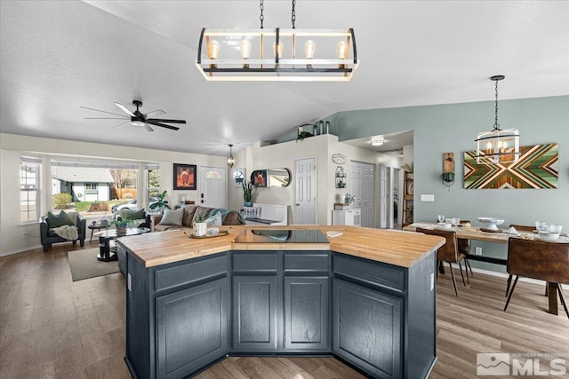 2036 Flycatcher Ct, Sparks, NV 89441 - kitchen with wood counters, vaulted ceiling, a chandelier, wood finished floors, and a ceiling fan