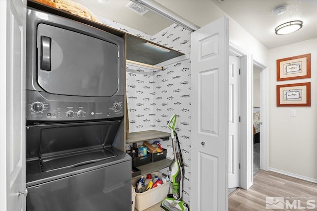 2036 Flycatcher Ct, Sparks, NV 89441 - laundry room with estacked washer and dryer, wood finished floors, and baseboards
