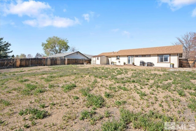 2036 Flycatcher Ct, Sparks, NV 89441 - fenced backyard featuring a storage shed and an outbuilding