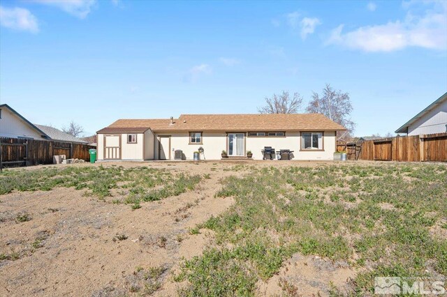 2036 Flycatcher Ct, Sparks, NV 89441 - rear view of property featuring a fenced backyard, a storage unit, and an outdoor structure