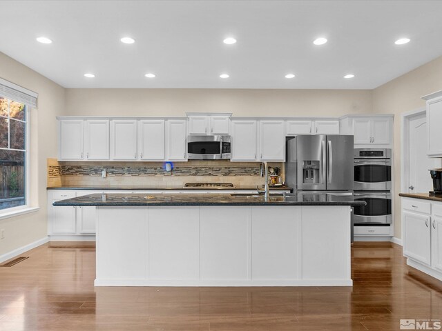 3240 Dunbar Ct, Sparks, NV 89436 - kitchen with stainless steel appliances, a sink, tasteful backsplash, white cabinetry, and recessed lighting