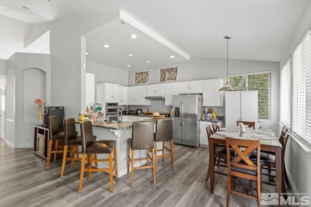 2525 Beaumont Pkwy, Reno, NV 89523 - dining area with light wood-type flooring, high vaulted ceiling, and recessed lighting