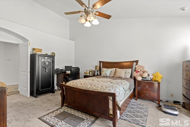 2525 Beaumont Pkwy, Reno, NV 89523 - bedroom with light colored carpet, arched walkways, a ceiling fan, and a towering ceiling