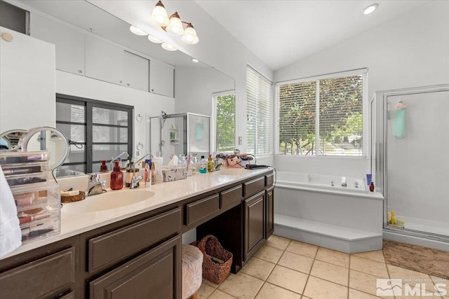 2525 Beaumont Pkwy, Reno, NV 89523 - bathroom featuring a shower stall, a garden tub, vaulted ceiling, double vanity, and tile patterned flooring