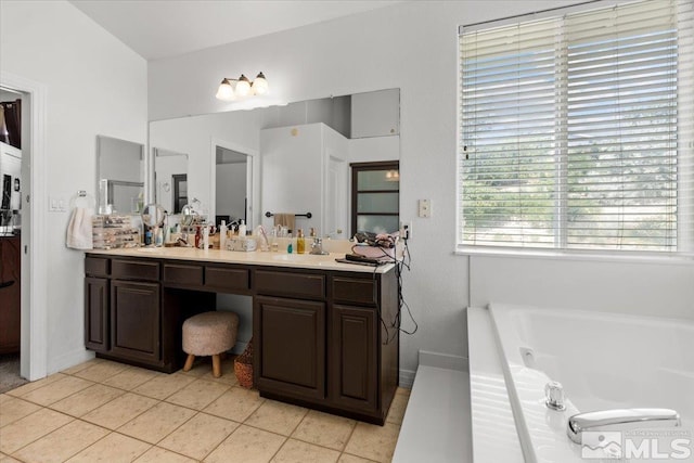 2525 Beaumont Pkwy, Reno, NV 89523 - bathroom featuring a bath, vanity, tile patterned floors, and baseboards