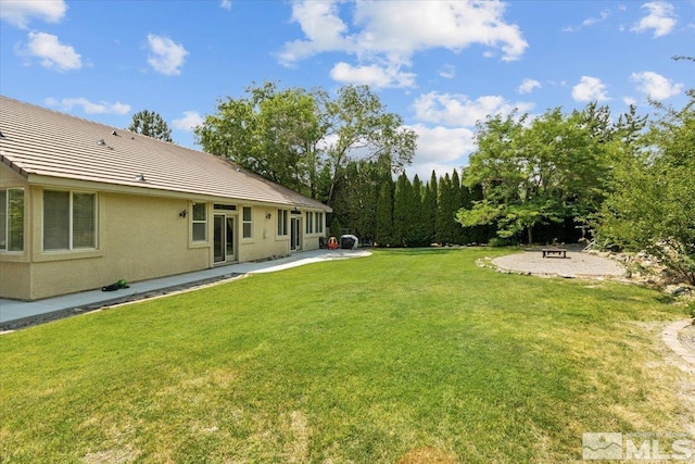 2525 Beaumont Pkwy, Reno, NV 89523 - view of grassy yard with a patio and a fire pit
