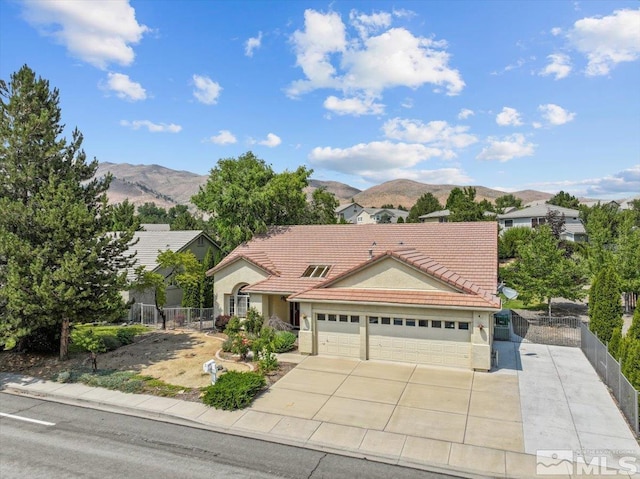 2525 Beaumont Pkwy, Reno, NV 89523 - view of front facade with a mountain view, a garage, a tile roof, and fence
