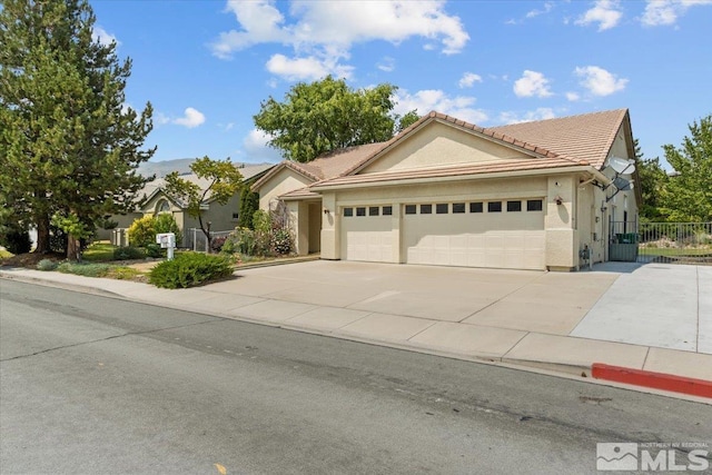 2525 Beaumont Pkwy, Reno, NV 89523 - single story home with an attached garage, driveway, a tiled roof, stucco siding, and fence