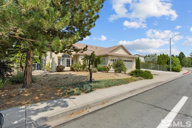 2525 Beaumont Pkwy, Reno, NV 89523 - ranch-style home with fence, an attached garage, driveway, and stucco siding