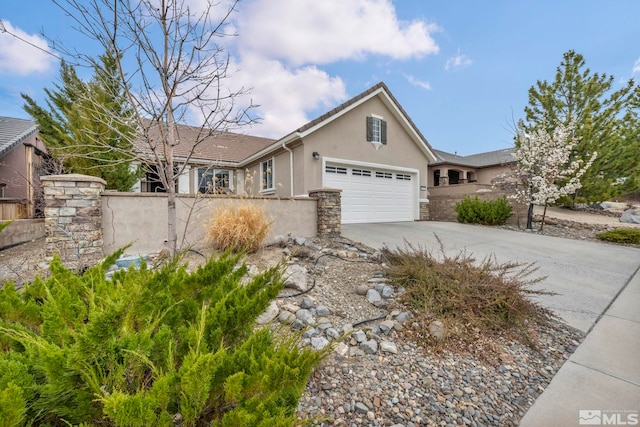 view of front of house featuring stucco siding, concrete driveway, a garage, fence, and stone siding