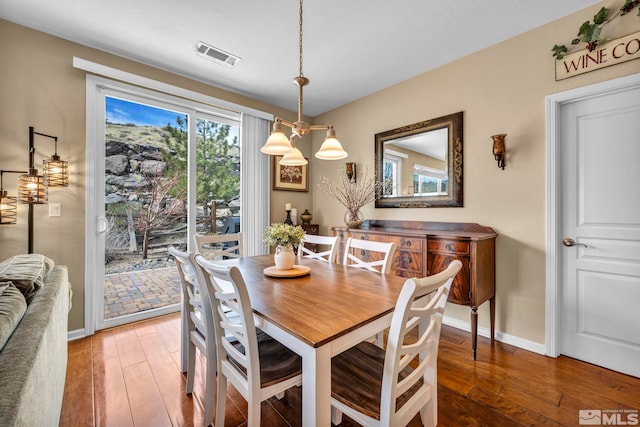 dining space featuring light wood-style floors and baseboards