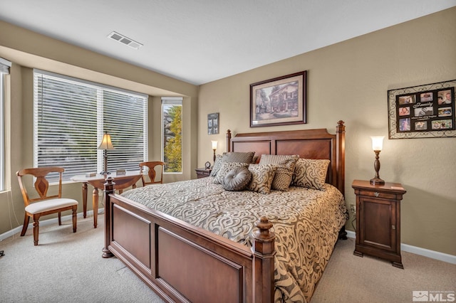 bedroom featuring light colored carpet and baseboards