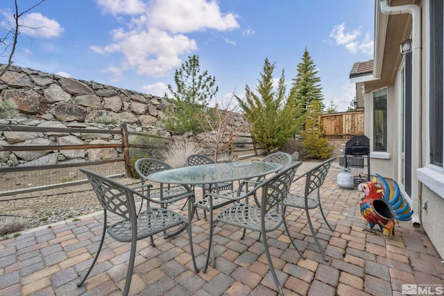 view of patio / terrace featuring outdoor dining area, area for grilling, and fence