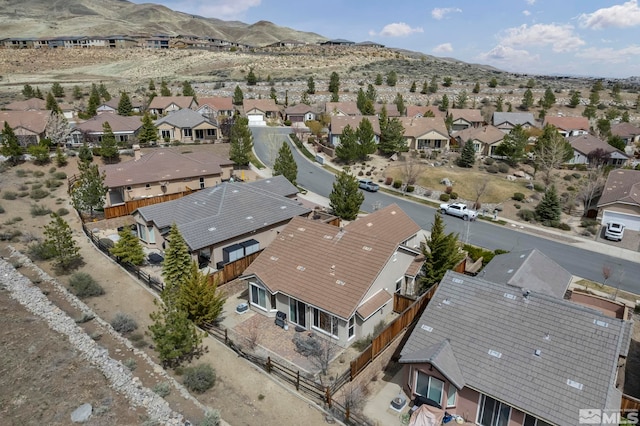 aerial view of property and surrounding area with nearby suburban area and a mountain backdrop