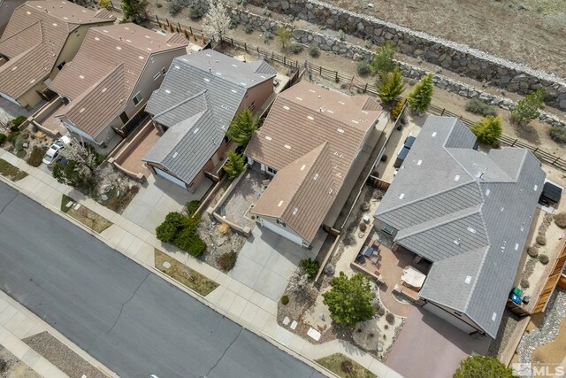 aerial view of property and surrounding area featuring nearby suburban area