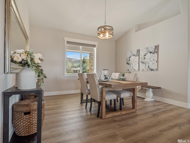 5376 S Edmonds Dr, Carson City, NV 89701 - dining space with lofted ceiling, light wood-type flooring, baseboards, and a chandelier