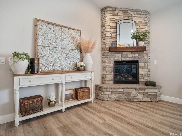 5376 S Edmonds Dr, Carson City, NV 89701 - sitting room with a stone fireplace, wood finished floors, baseboards, and vaulted ceiling