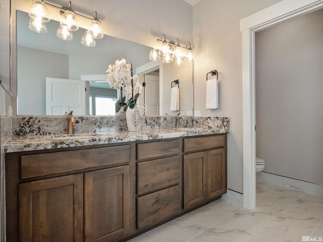5376 S Edmonds Dr, Carson City, NV 89701 - bathroom with marble finish flooring, toilet, and double vanity