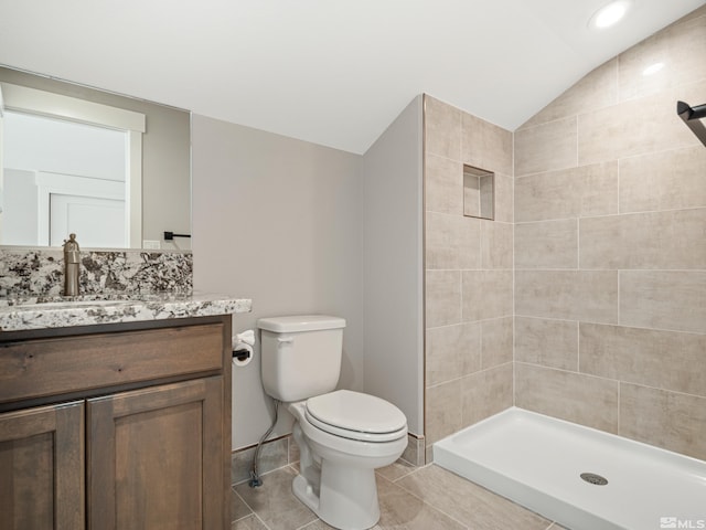 5376 S Edmonds Dr, Carson City, NV 89701 - bathroom featuring toilet, vanity, vaulted ceiling, a stall shower, and tile patterned flooring
