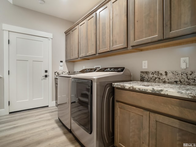 5376 S Edmonds Dr, Carson City, NV 89701 - clothes washing area with cabinet space, washer and clothes dryer, and light wood-type flooring