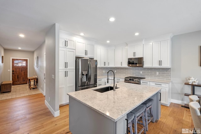 5989 Hidden Highlands Dr, Reno, NV 89502 - kitchen with stainless steel appliances, a sink, light wood-style flooring, baseboards, and recessed lighting