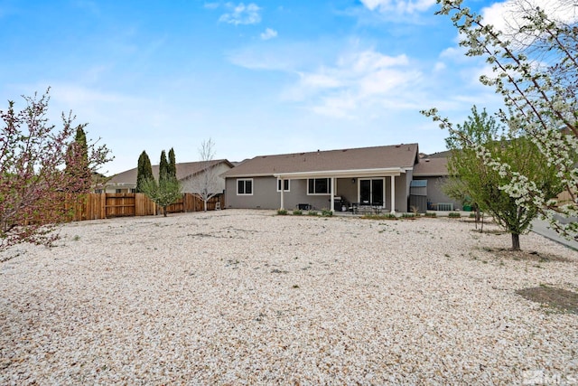 5989 Hidden Highlands Dr, Reno, NV 89502 - back of property featuring fence, a patio area, and stucco siding