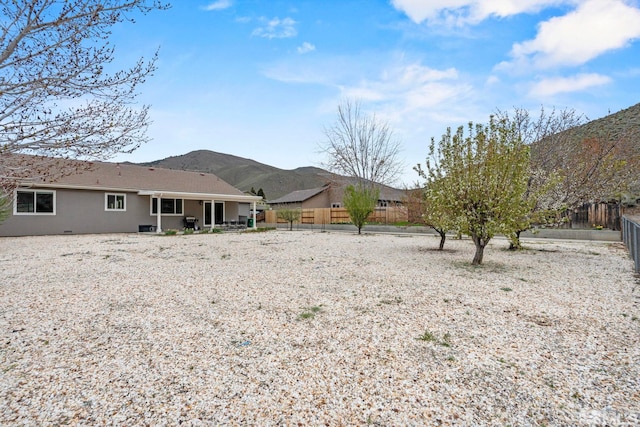 5989 Hidden Highlands Dr, Reno, NV 89502 - rear view of house with a mountain view and stucco siding
