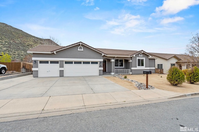 5989 Hidden Highlands Dr, Reno, NV 89502 - single story home with stucco siding, an attached garage, concrete driveway, and covered porch