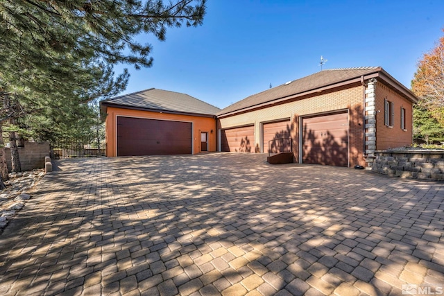 2501 Kensington Pl, Carson City, NV 89703 - view of front of property featuring decorative driveway, brick siding, fence, and an attached garage