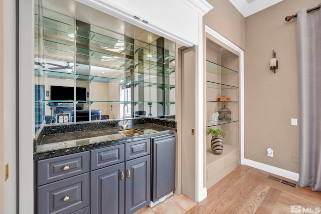 2501 Kensington Pl, Carson City, NV 89703 - bar featuring a sink, a ceiling fan, crown molding, baseboards, and light wood-style floors