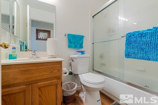 248 Woodlake Cir, Dayton, NV 89403 - bathroom featuring toilet, vanity, enclosed tub / shower combo, and wood finished floors