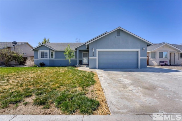 989 Julia Ln, Fernley, NV 89408 - ranch-style house featuring an attached garage, driveway, a front yard, and stucco siding