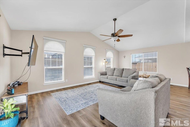 989 Julia Ln, Fernley, NV 89408 - living area featuring a ceiling fan, vaulted ceiling, wood finished floors, and baseboards