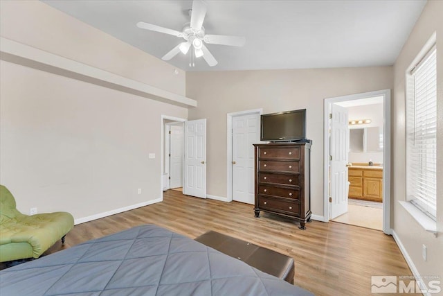 989 Julia Ln, Fernley, NV 89408 - bedroom featuring vaulted ceiling, light wood-type flooring, baseboards, connected bathroom, and ceiling fan