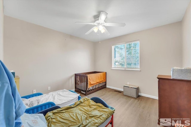 989 Julia Ln, Fernley, NV 89408 - bedroom with wood finished floors, baseboards, and ceiling fan