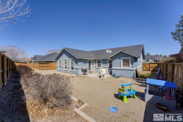 989 Julia Ln, Fernley, NV 89408 - back of house featuring stucco siding, a fenced backyard, and a patio area