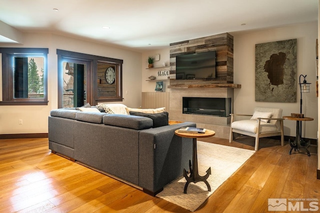 17 Beach Club Dr Unit 221, Stateline, NV 89449 - living area featuring hardwood / wood-style flooring, a tiled fireplace, and baseboards