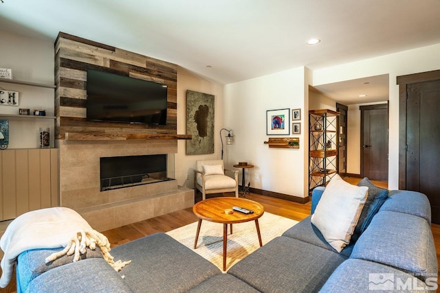 17 Beach Club Dr Unit 221, Stateline, NV 89449 - living area with wood finished floors, a tiled fireplace, baseboards, recessed lighting, and vaulted ceiling