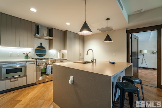 17 Beach Club Dr Unit 221, Stateline, NV 89449 - kitchen with wall chimney exhaust hood, stainless steel appliances, light wood-style flooring, a sink, and recessed lighting