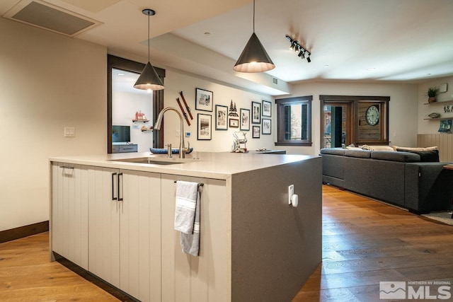 17 Beach Club Dr Unit 221, Stateline, NV 89449 - kitchen featuring a sink, open floor plan, pendant lighting, light wood-type flooring, and light countertops