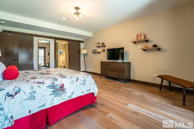17 Beach Club Dr Unit 221, Stateline, NV 89449 - bedroom with a barn door, wood finished floors, and baseboards