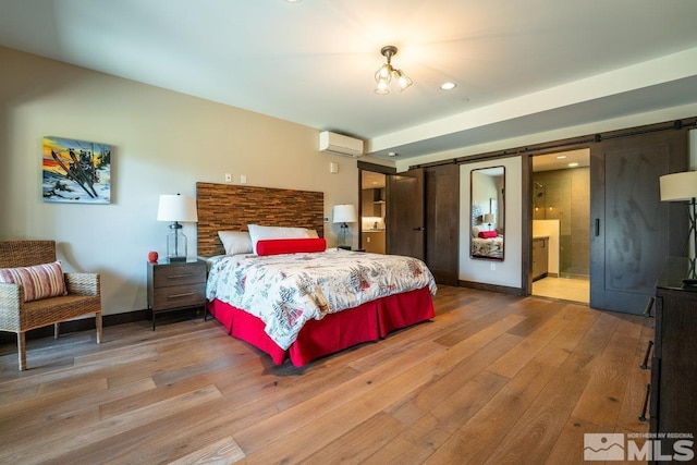 17 Beach Club Dr Unit 221, Stateline, NV 89449 - bedroom with a barn door, an AC wall unit, wood finished floors, recessed lighting, and baseboards
