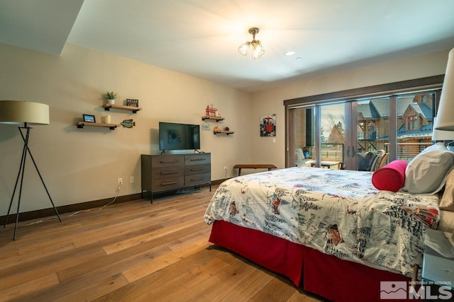 17 Beach Club Dr Unit 221, Stateline, NV 89449 - bedroom featuring hardwood / wood-style flooring, baseboards, and access to exterior